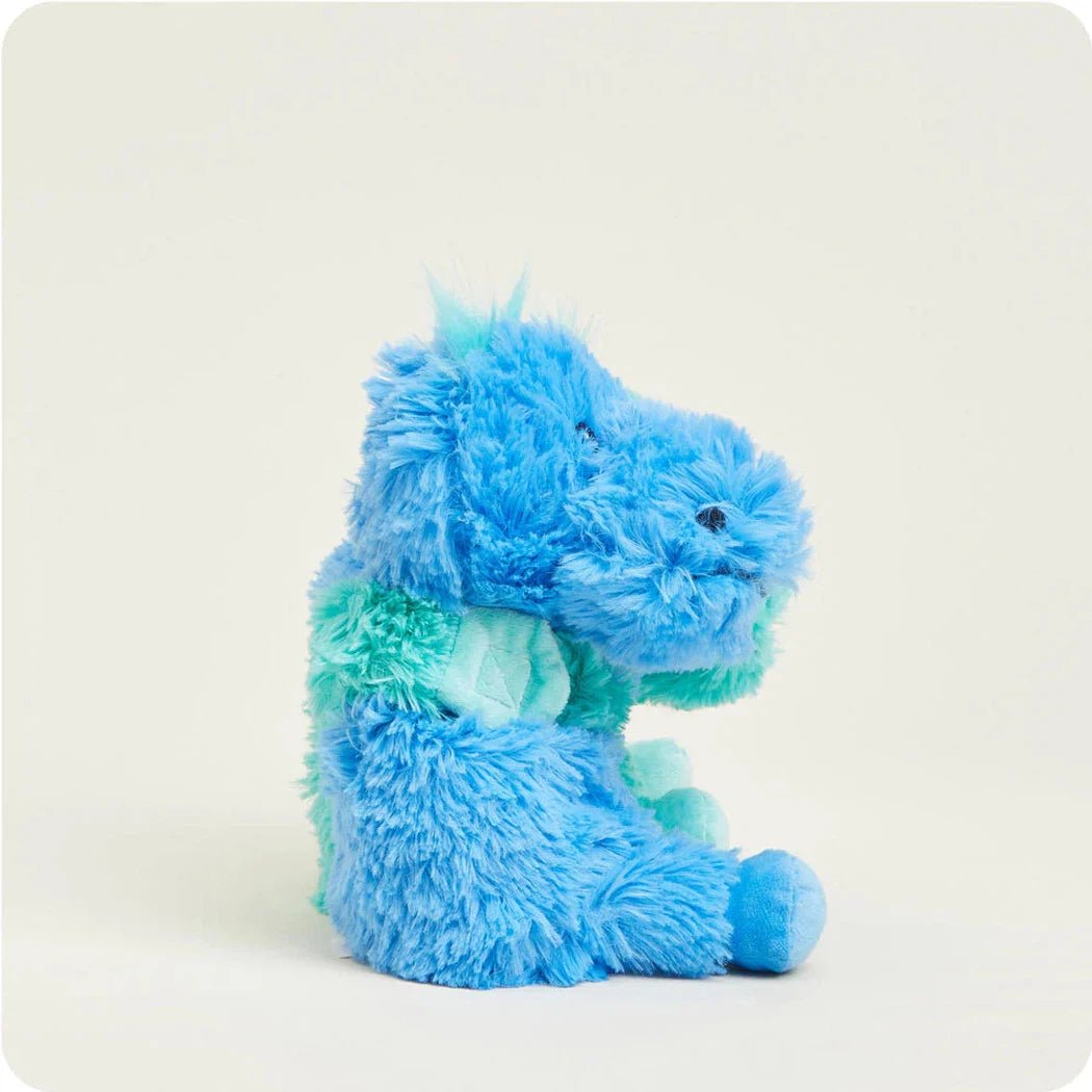 Side view of the Warmies Dinosaur Hugs plush toy with blue and teal fur against a plain white background.