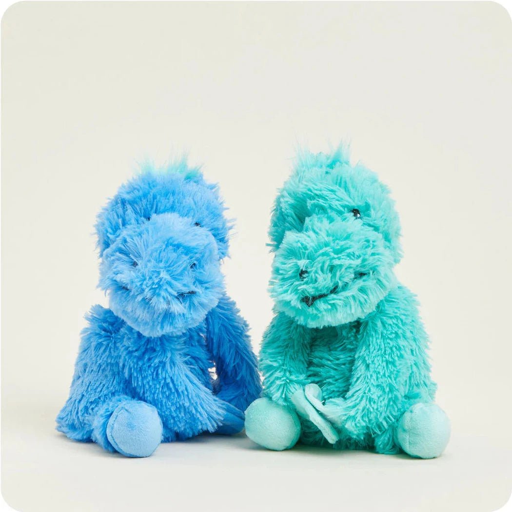 Two Warmies Dinosaur Hugs plush toys in blue and teal sit side by side against a plain white background.