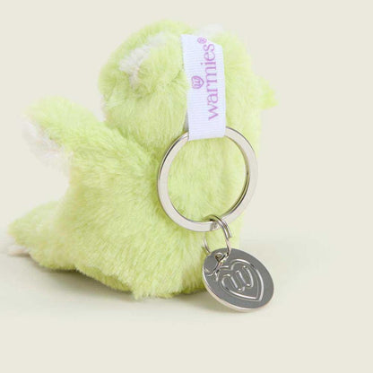 A close-up of the Warmies Frog Keyring in light green with a silver heart charm and white tag against a plain background.