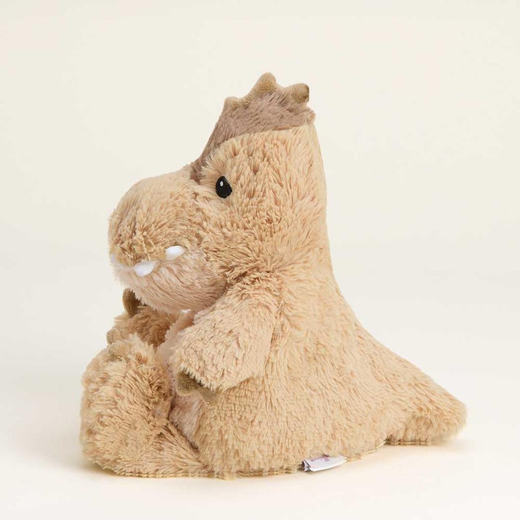 A side view of the Warmies Megalosaurus plush toy with a brown crown and white teeth against a plain white background.