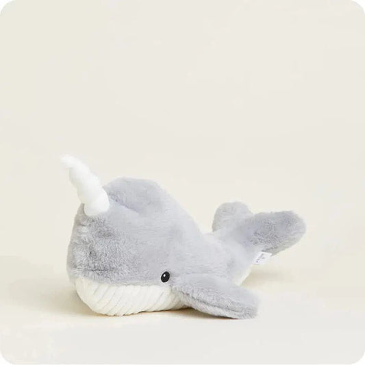 A side view of the Warmies Narwhal plush toy with a white horn and a light gray body against a plain background.