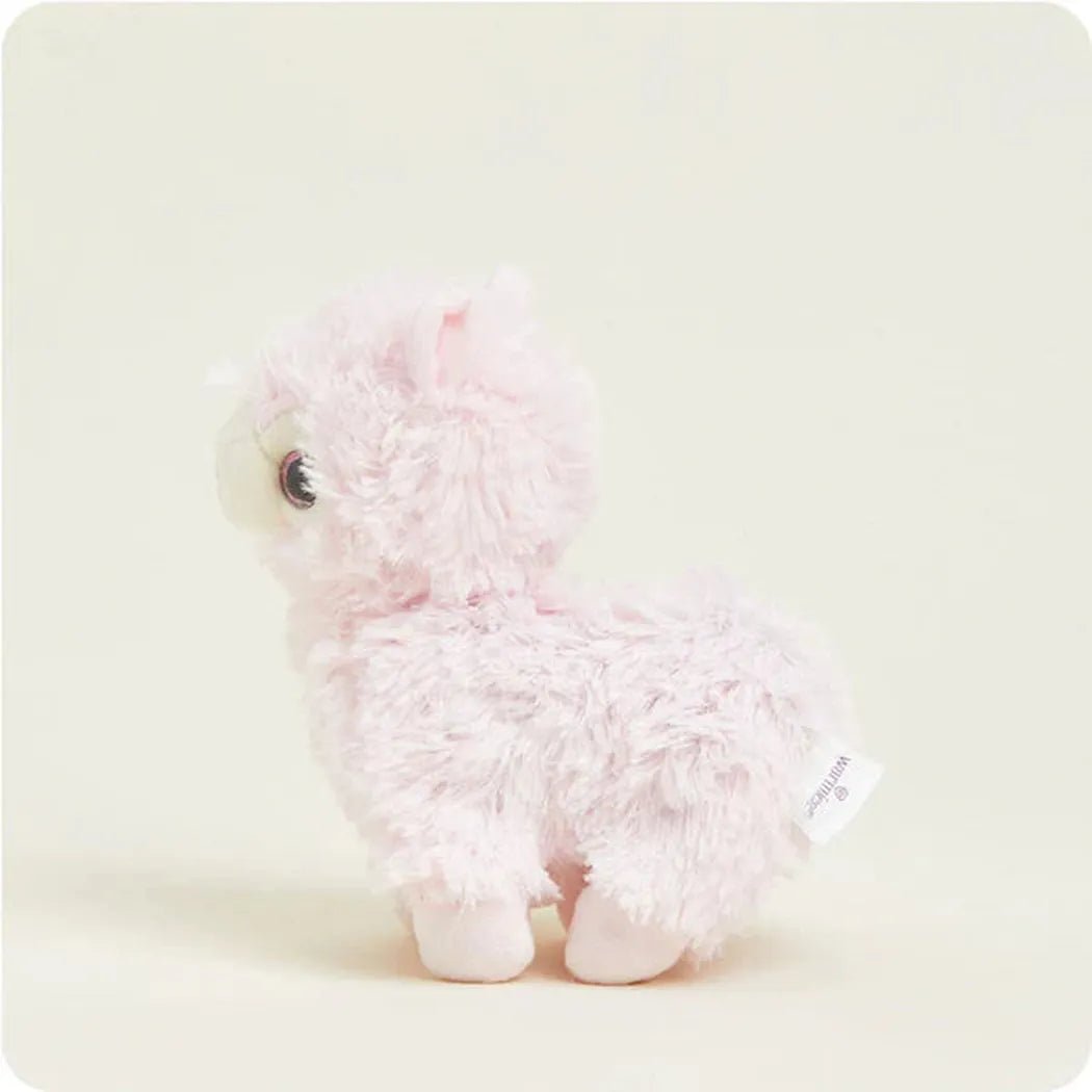 A side view of the Warmies Pink Llama Junior plush toy against a light background.
