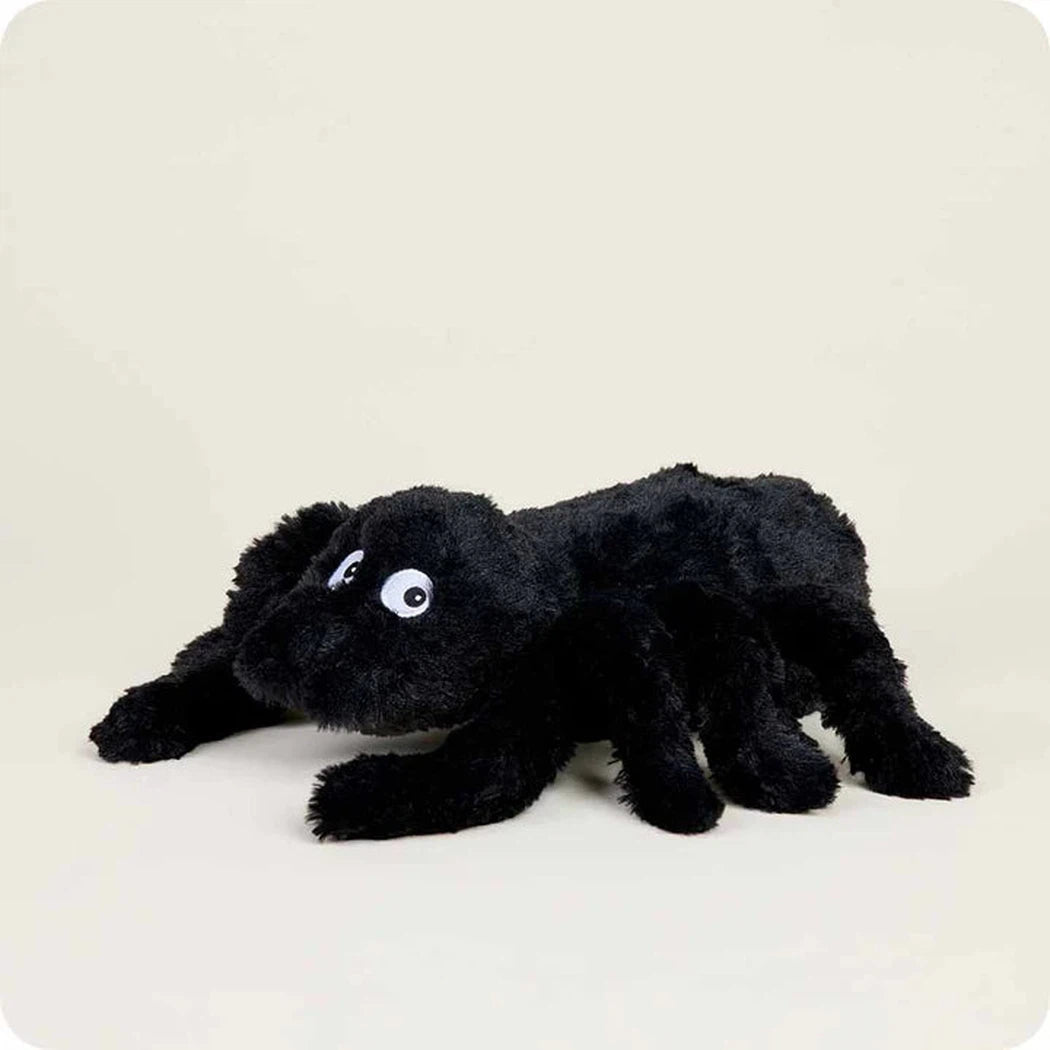A front view of the Warmies Spider plush toy with large white eyes and a black body against a plain light background.