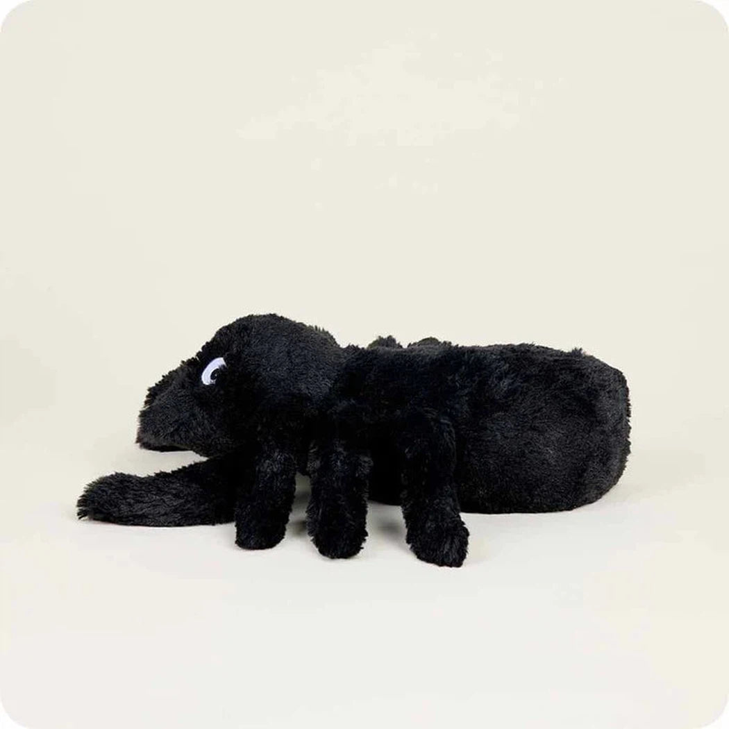 A side view of the Warmies Spider plush toy lying down against a plain white background.