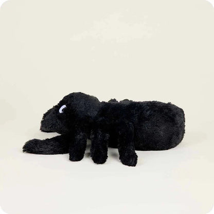 A side view of the Warmies Spider plush toy lying down against a plain white background.