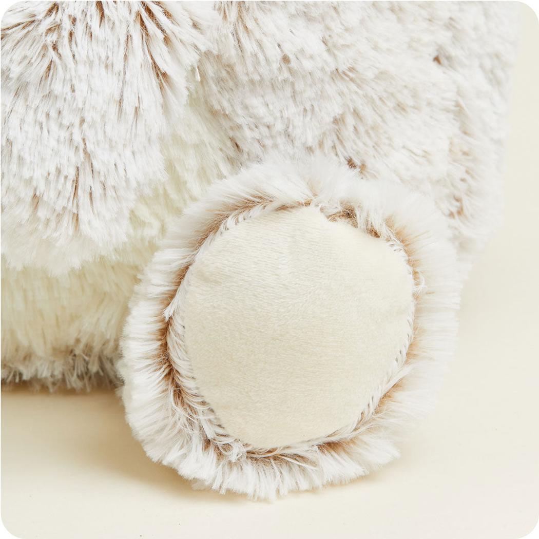 A close-up of the Warmies Supersized Bear showing its fluffy paw and soft fur texture.