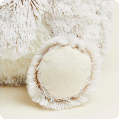 A close-up of the Warmies Supersized Bear showing its fluffy paw and soft fur texture.