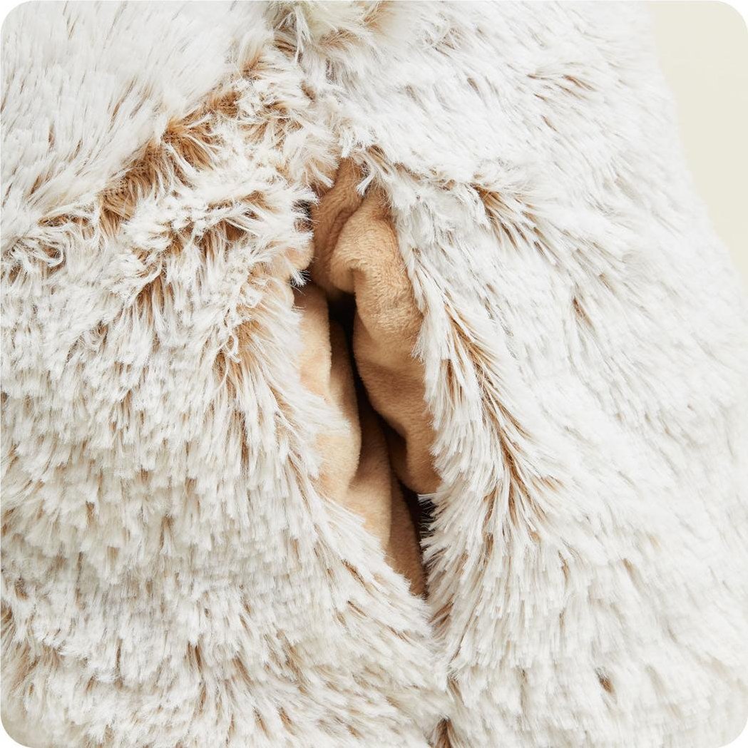 A close-up of the Warmies Supersized Bear shows a hand peeking out from its soft, white fur.