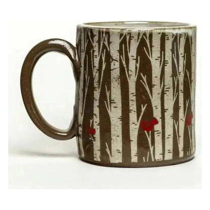A side view of the White Squirrel Clayworks Limited Birch Trees Chocolate Clay Handmade Ceramic 12oz Mug showing the birch tree design and red accents against a white background.