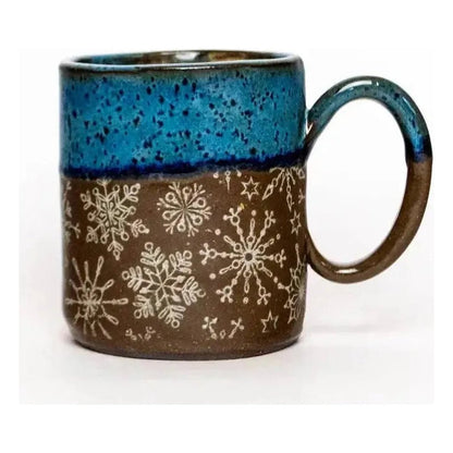 A front view of the White Squirrel Clayworks Limited Winter Snowflake Handmade Ceramic Blue 14oz Mug showing the snowflake pattern against a white background.