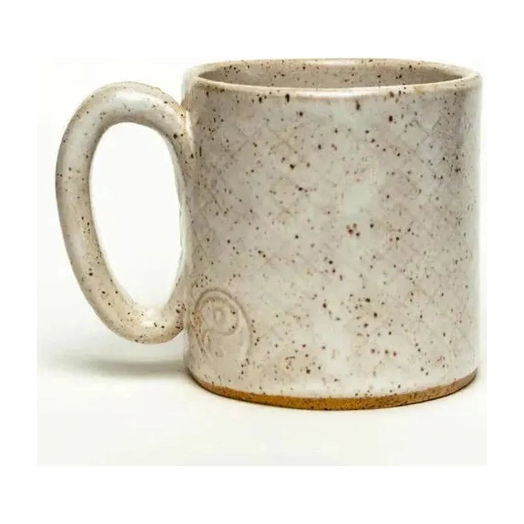 A front view of the White Squirrel Clayworks Woodpecker Design Handmade, in Ohio, Ceramic White 10oz Mug showing its speckled glaze and handle against a white background.