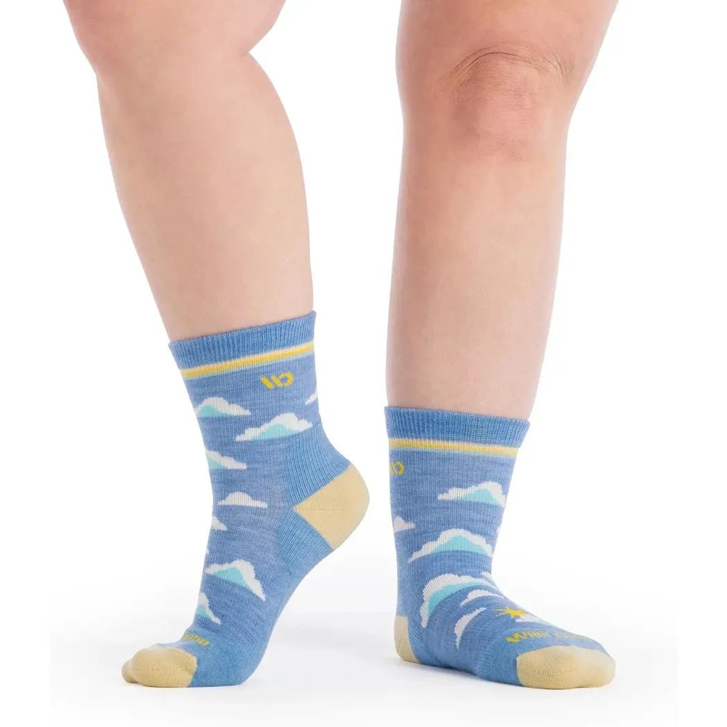 Side view of the Wide Open Women's Cloud Hopper Midweight Micro Crew Sock in Sky showing the cloud pattern and yellow toe against a white background.