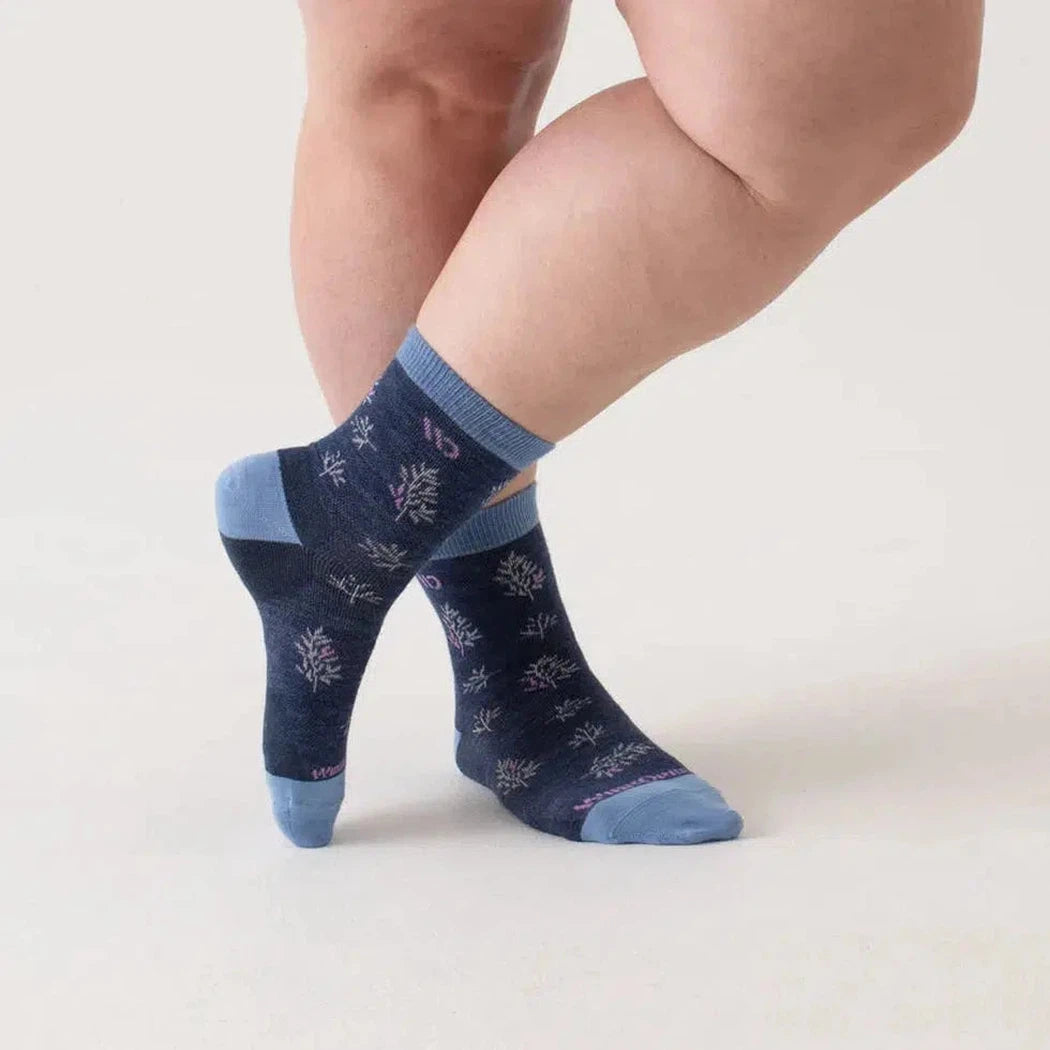 A woman wearing Wide Open Women's Foliage Lightweight Micro Crew Sock in Denim, showing the ankle and foot with a white background.