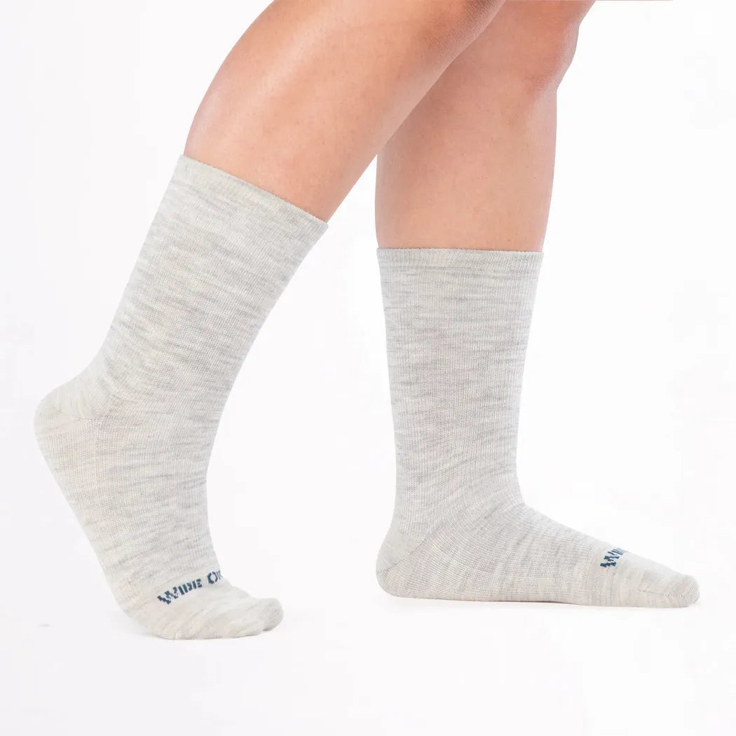 Side view of the Wide Open Women's Solid Basic Crew Lightweight No Cushion Socks in Ash on a model against a white background.