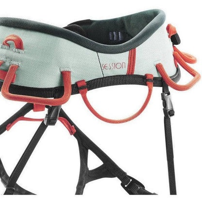 A close-up of the Wild Country Session Women's climbing harness in Aquifer/Orange, showing the padded waistbelt and orange gear loops against a white background.