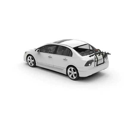 A white sedan with a Yakima FullBack bike rack mounted on its rear, photographed from a three-quarter angle against a plain white background.
