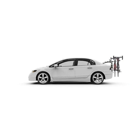 Side view of the Yakima HalfBack 3 car rack holding two bikes against a white background.