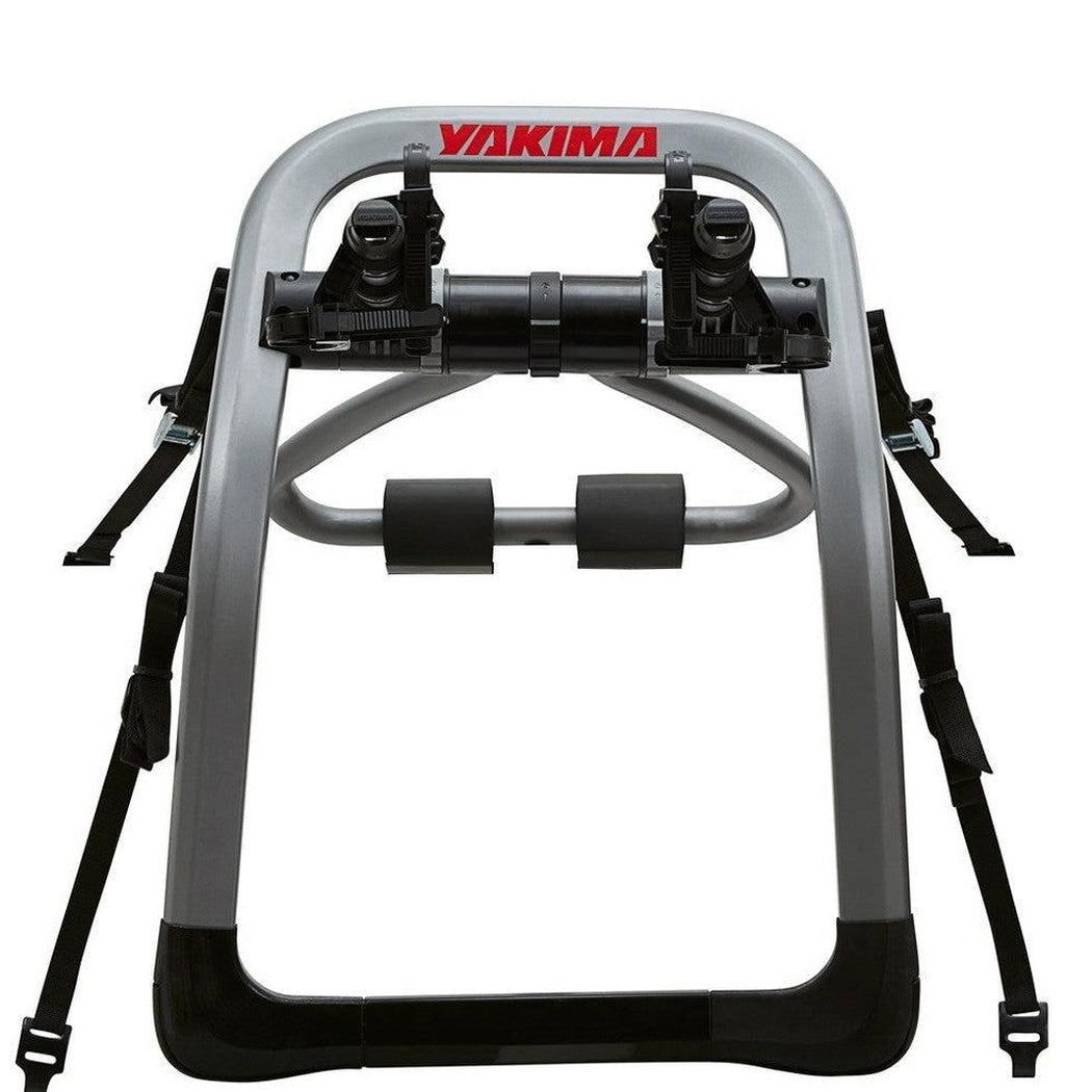 A front view of the Yakima HalfBack bike car rack with black straps and a silver frame against a white background.