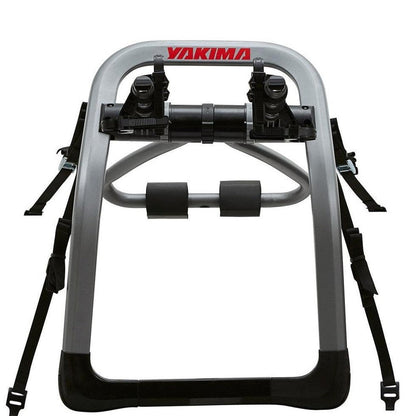 A front view of the Yakima HalfBack bike car rack with black straps and a silver frame against a white background.