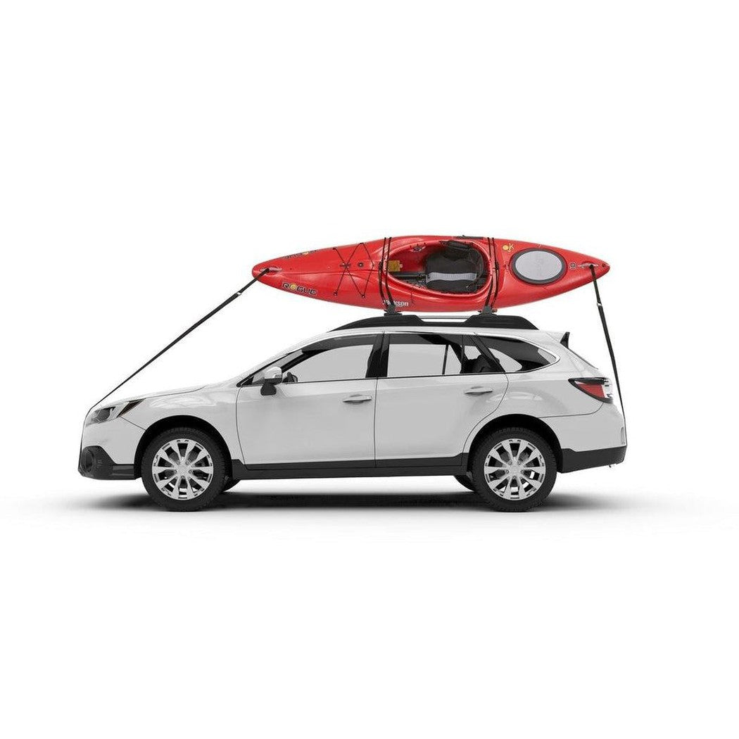 A white SUV with a red kayak secured on a Yakima JayLow car rack, shown from the side against a plain white background.