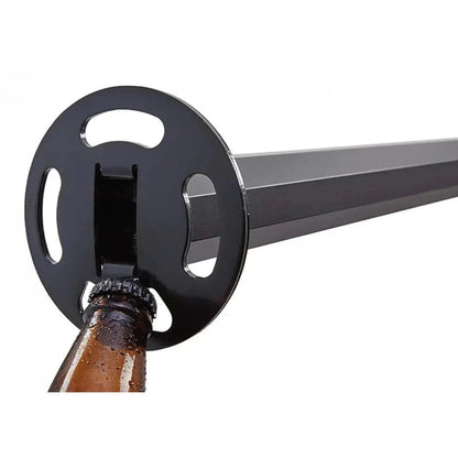 A close-up of the Yakima LongArm car rack in charcoal/graphite color, showing the circular mounting plate and a beer bottle being opened with it.