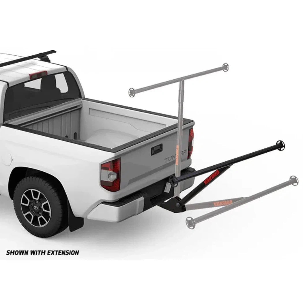 A rear view of a white pickup truck with the Yakima LongArm rack system installed, showing the extension arm and hitch mount against a plain white background.