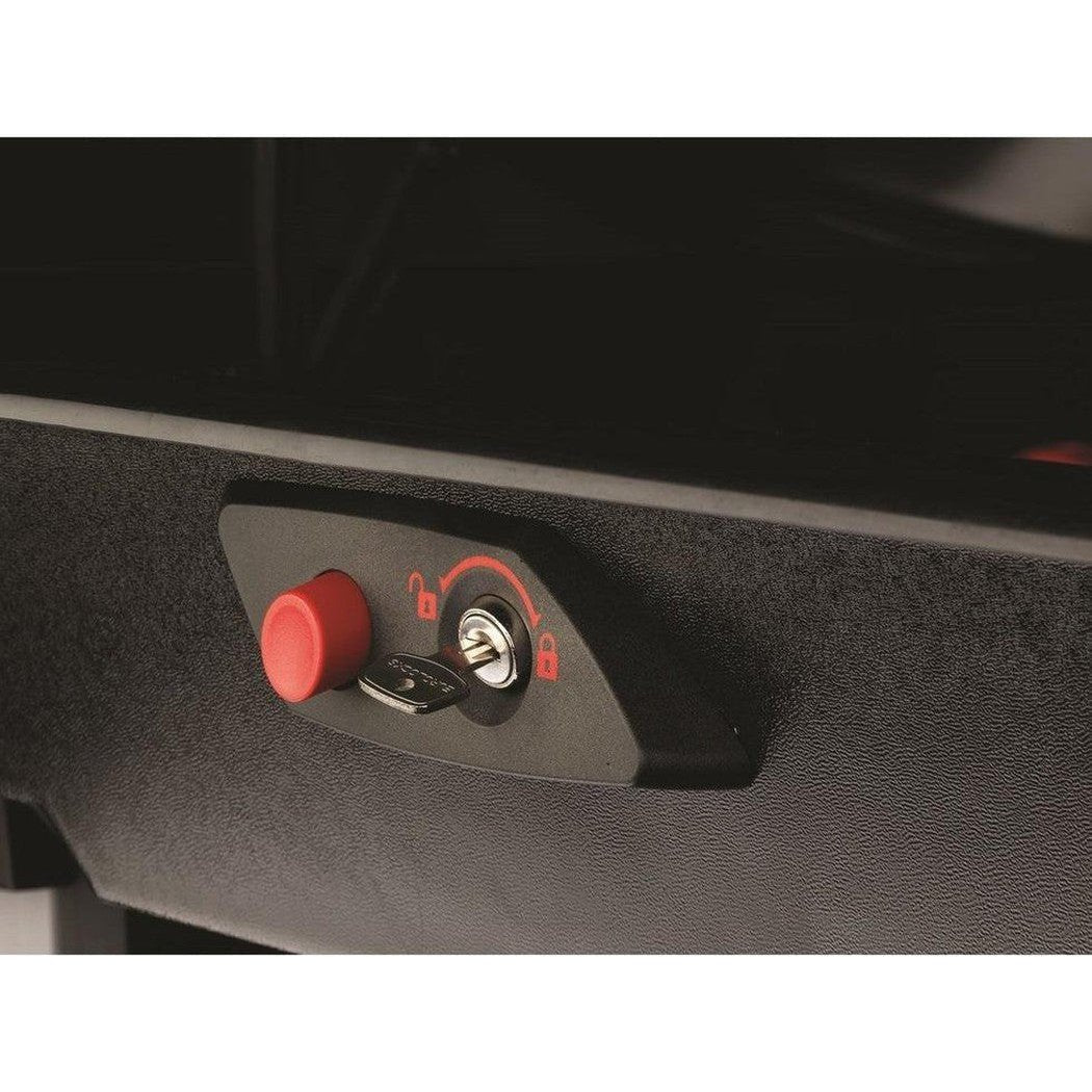 A close-up of the Yakima Rocketbox Pro 14 showing the red emergency release button and key lock on a charcoal-colored surface.