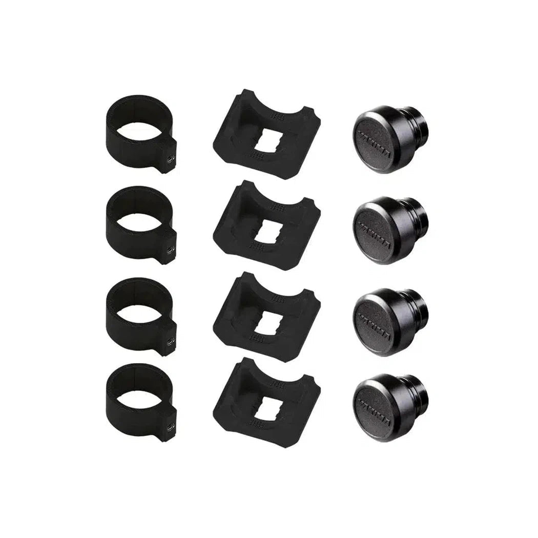 Four black Yakima RoundBar SL adapters with square cutouts and matching caps arranged on a white background.